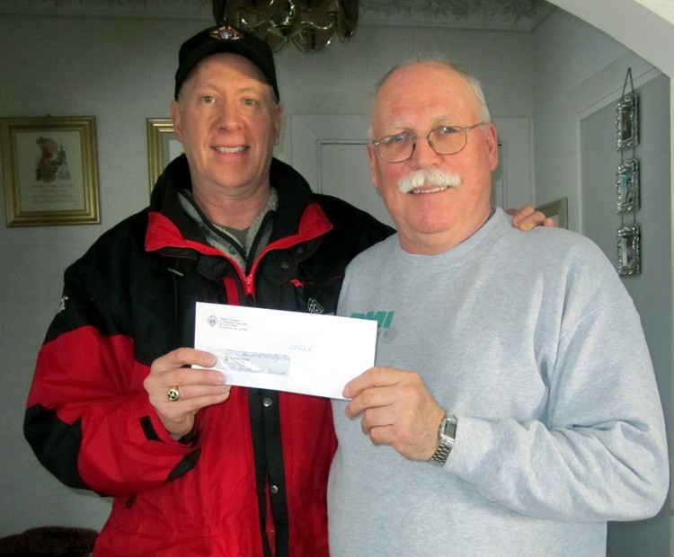 Brian Whittaker from Knights of Columbus 1394 
presents cheque to 50/50 Draw Winner Corny Holierhoek - Click to Enlarge